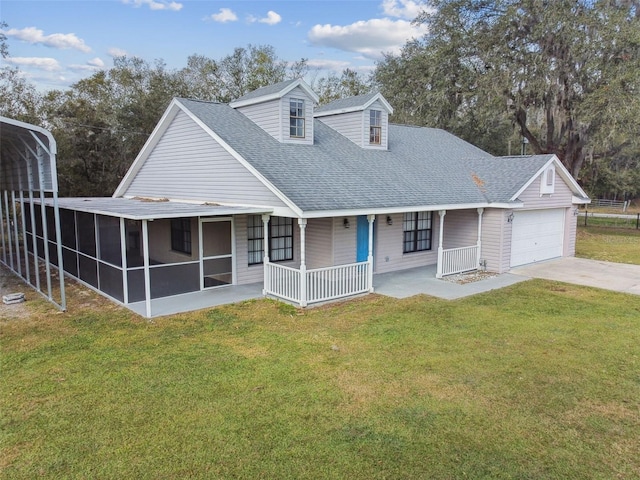 view of front of property featuring a sunroom, a porch, a garage, and a front lawn