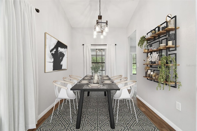 dining room with a chandelier and dark hardwood / wood-style floors