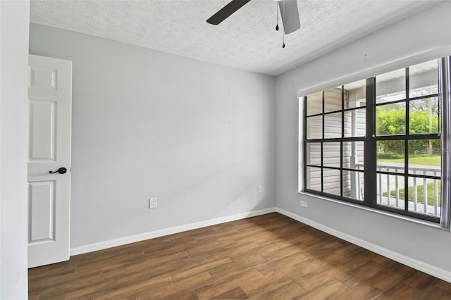 empty room featuring ceiling fan, wood-type flooring, and a textured ceiling