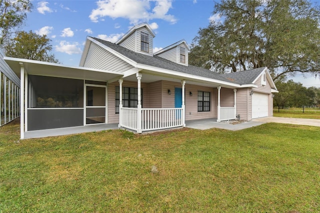 view of front of property featuring a front lawn, covered porch, and a garage