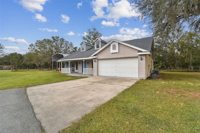 view of front of house featuring central air condition unit, covered porch, a front yard, and a garage