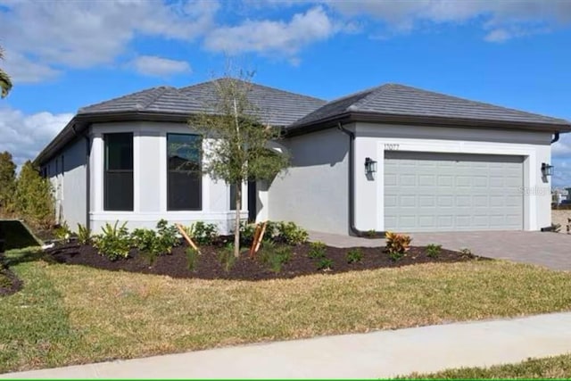 view of front of house with a front lawn and a garage