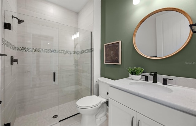 bathroom featuring tile patterned floors, vanity, an enclosed shower, and toilet