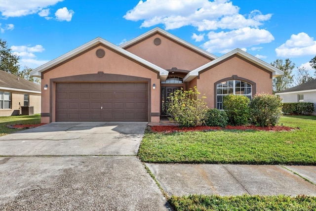 ranch-style home with cooling unit, a garage, and a front yard