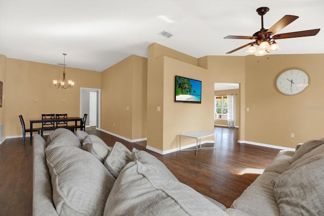 living room with dark wood-type flooring and ceiling fan with notable chandelier