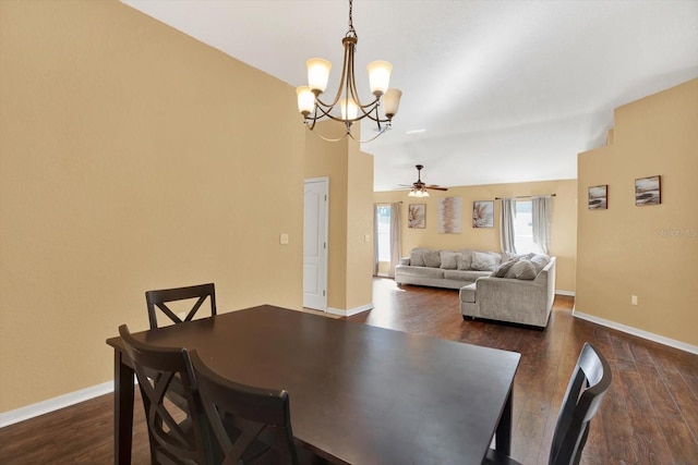 dining room featuring ceiling fan with notable chandelier, dark hardwood / wood-style floors, and lofted ceiling