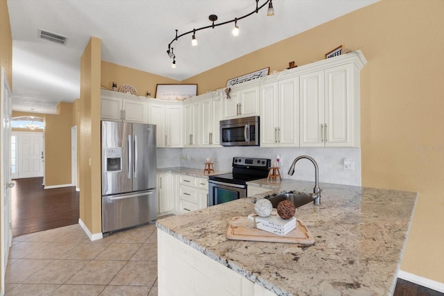 kitchen with kitchen peninsula, white cabinetry, and stainless steel appliances