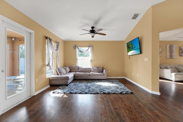 living room with ceiling fan, dark hardwood / wood-style flooring, and vaulted ceiling