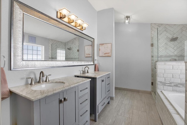 bathroom with vanity and separate shower and tub