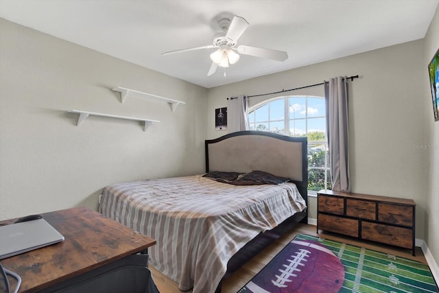 bedroom with ceiling fan and dark wood-type flooring