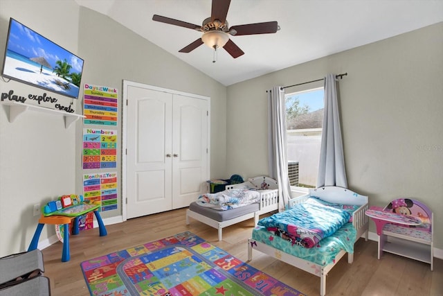 playroom featuring ceiling fan, wood-type flooring, and lofted ceiling