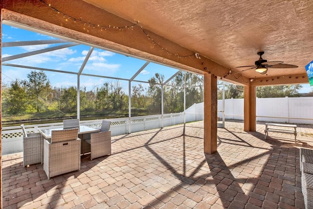 view of patio / terrace featuring glass enclosure and ceiling fan