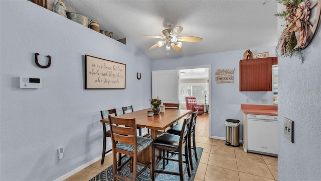 dining area featuring ceiling fan, a textured ceiling, and light tile patterned floors