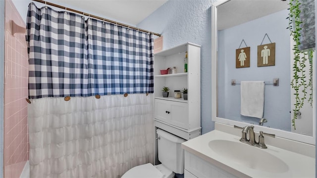 bathroom with toilet and vanity