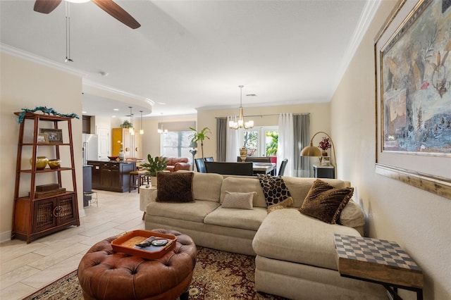 living room with ceiling fan with notable chandelier and ornamental molding