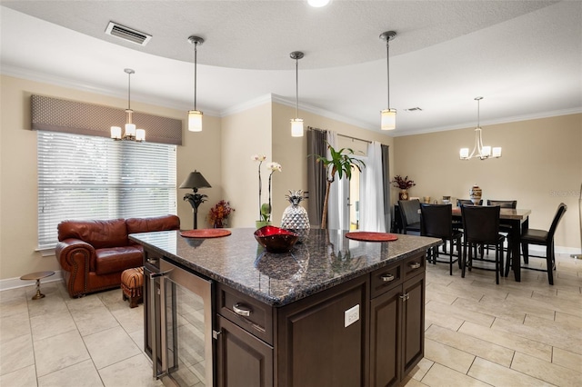 kitchen featuring a notable chandelier, hanging light fixtures, and wine cooler