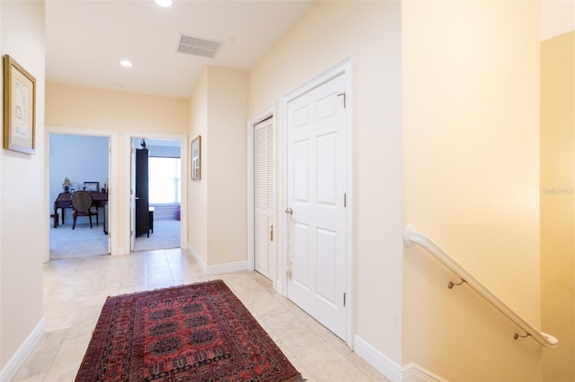 corridor with light tile patterned flooring