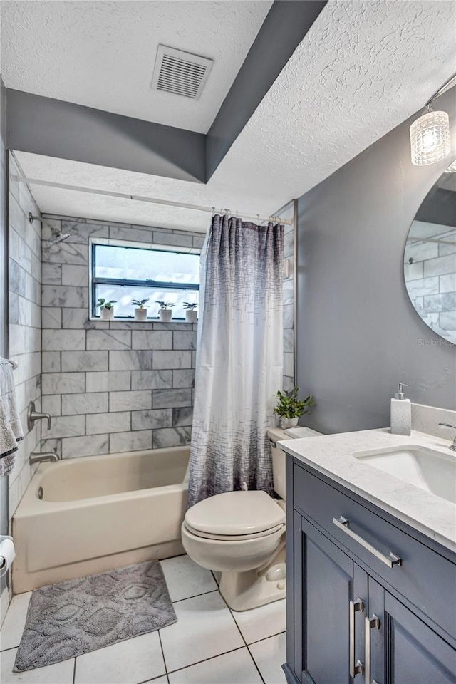 full bathroom featuring tile patterned floors, a textured ceiling, toilet, shower / bath combo with shower curtain, and vanity