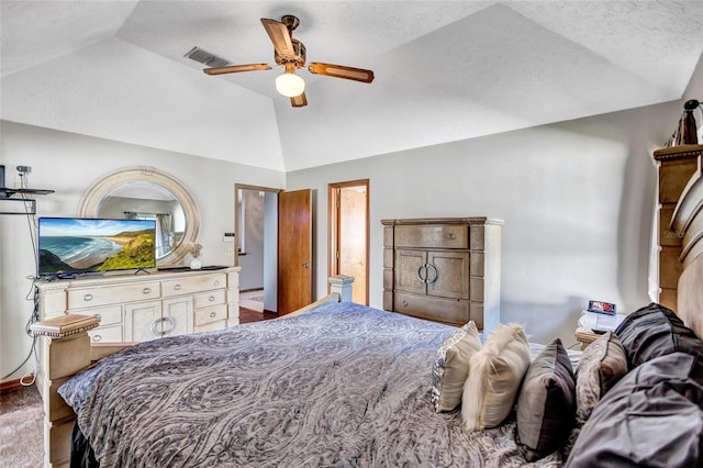 bedroom with a raised ceiling, ceiling fan, and vaulted ceiling