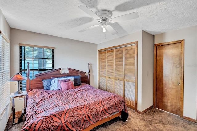 carpeted bedroom with ceiling fan, a textured ceiling, and a closet