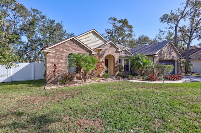 view of front of property featuring a front lawn and a garage