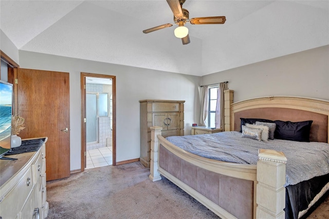 bedroom with light carpet, ensuite bath, vaulted ceiling, and ceiling fan