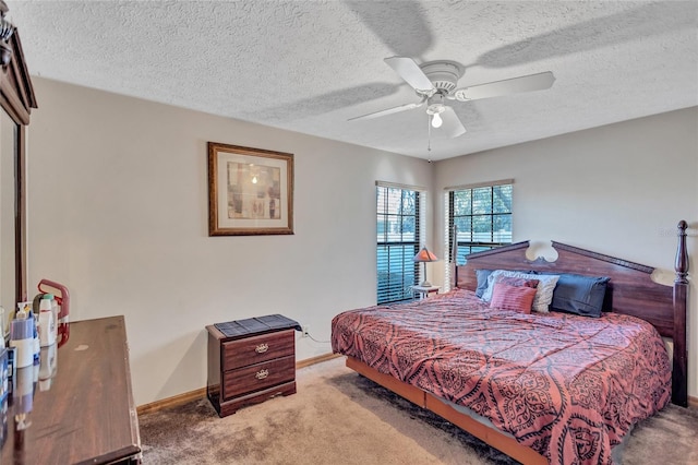 bedroom with a textured ceiling, carpet floors, and ceiling fan