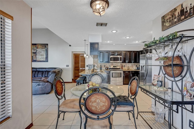 dining room with light tile patterned floors and a textured ceiling