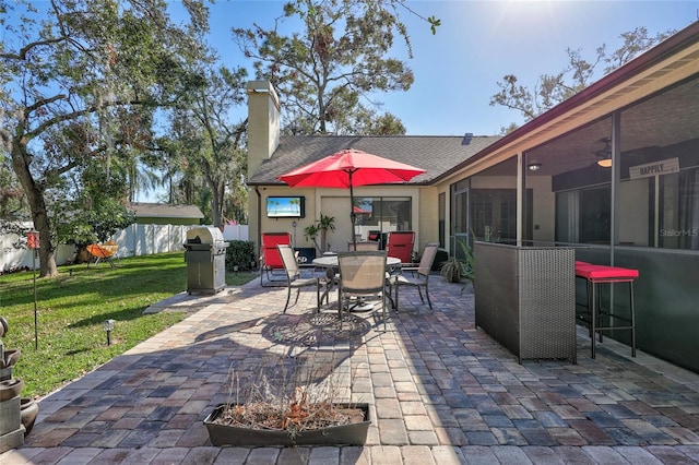 view of patio featuring ceiling fan and a grill