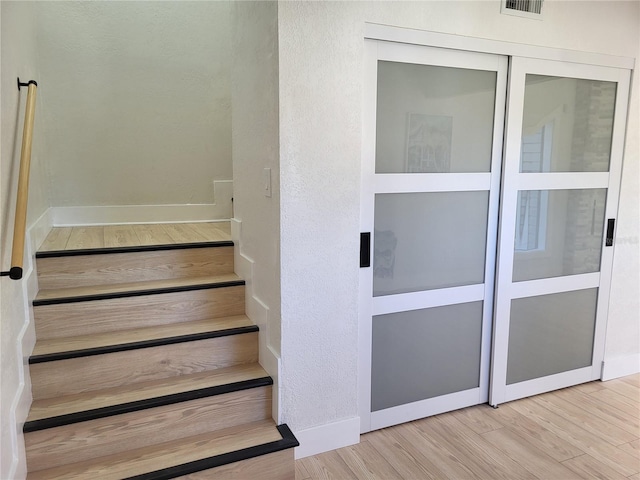 stairway featuring hardwood / wood-style flooring