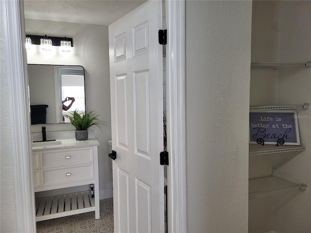 bathroom featuring vanity and a textured ceiling