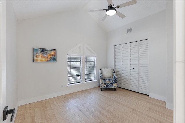 unfurnished room featuring ceiling fan, high vaulted ceiling, and light wood-type flooring