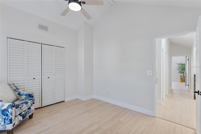 unfurnished bedroom with light wood-type flooring, a closet, high vaulted ceiling, and ceiling fan