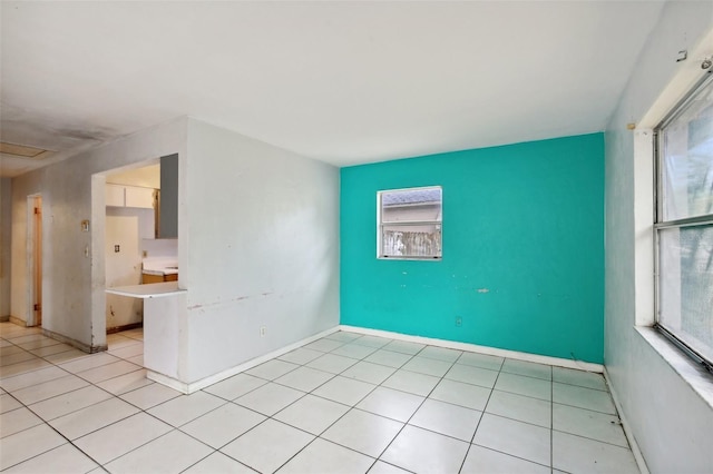 tiled spare room with a healthy amount of sunlight