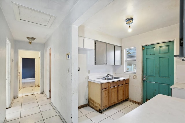 kitchen with light tile patterned floors and sink