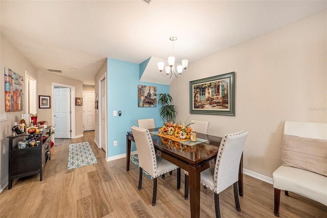 dining space featuring a chandelier and hardwood / wood-style floors