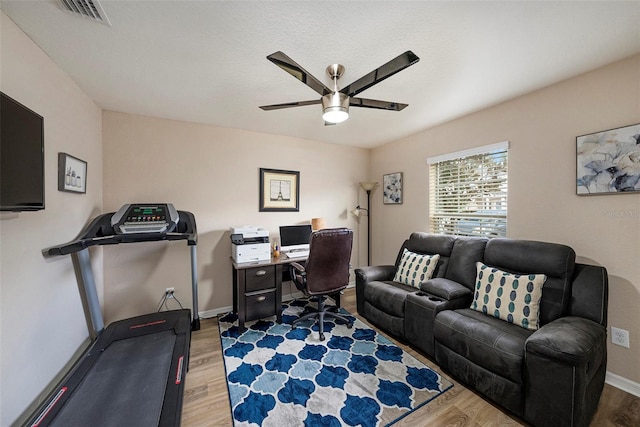 office space with ceiling fan and light wood-type flooring