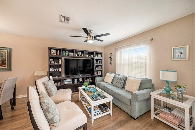 living room featuring hardwood / wood-style flooring and ceiling fan