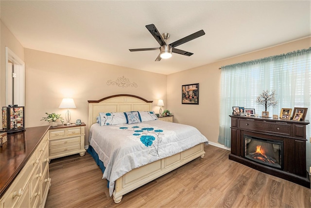 bedroom with wood-type flooring and ceiling fan