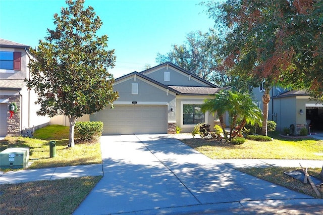 view of front of property with a front yard and a garage