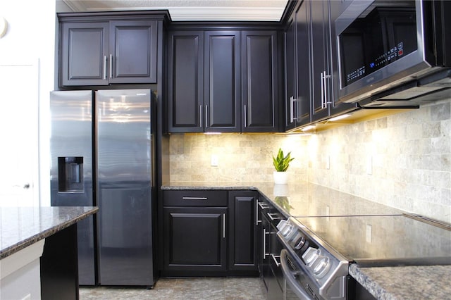 kitchen with tasteful backsplash, light stone counters, and appliances with stainless steel finishes