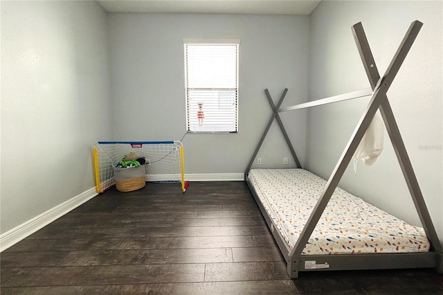 unfurnished bedroom with dark hardwood / wood-style flooring