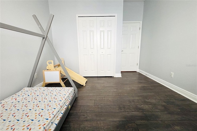 bedroom featuring a closet and dark wood-type flooring