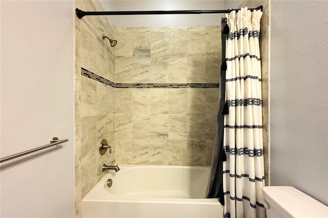 bathroom featuring toilet and shower / bath combo with shower curtain