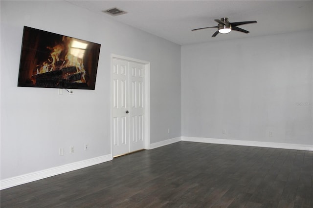 spare room with ceiling fan and dark wood-type flooring