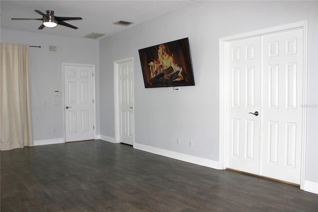 spare room featuring dark hardwood / wood-style floors and ceiling fan