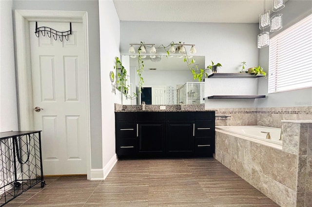 bathroom with vanity and independent shower and bath