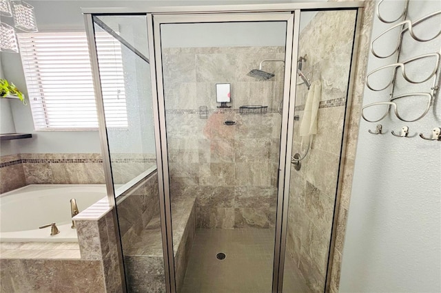 bathroom featuring shower with separate bathtub