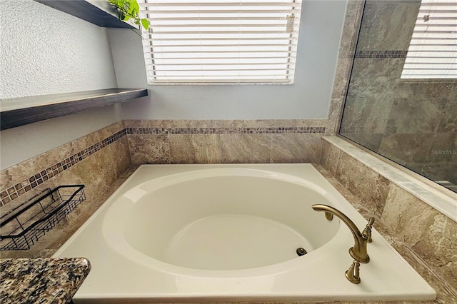 bathroom featuring tiled tub