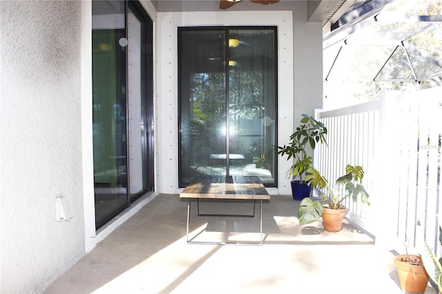 view of exterior entry featuring ceiling fan